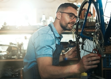 Bike shop owner working on bicycle